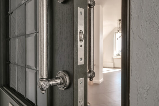 door handle on white wooden door in interior. Knob close-up elements. Door handle, fittings for interior design