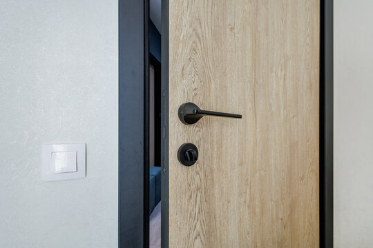door handle on white wooden door in interior. Knob close-up elements. Door handle, fittings for interior design
