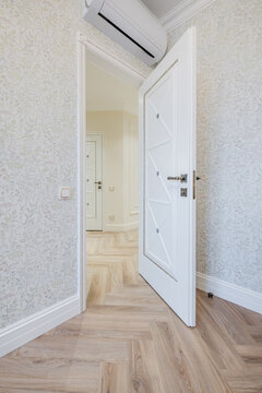 door handle on white wooden door in interior. Knob close-up elements. Door handle, fittings for interior design