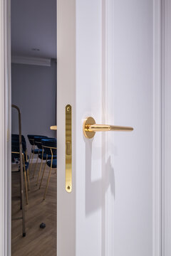 door handle on white wooden door in interior. Knob close-up elements. Door handle, fittings for interior design