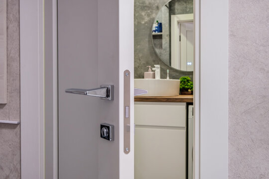 door handle on white wooden door in interior. Knob close-up elements. Door handle, fittings for interior design