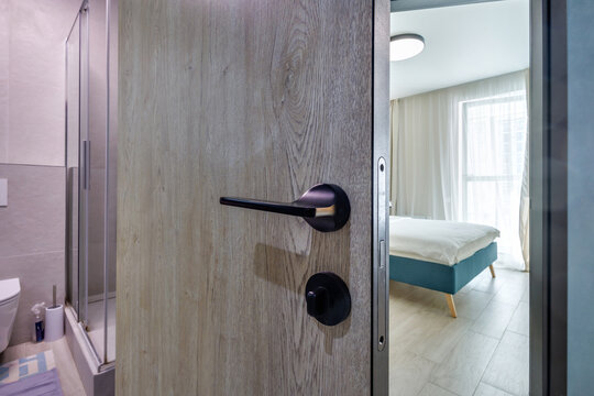 door handle on white wooden door in interior. Knob close-up elements. Door handle, fittings for interior design