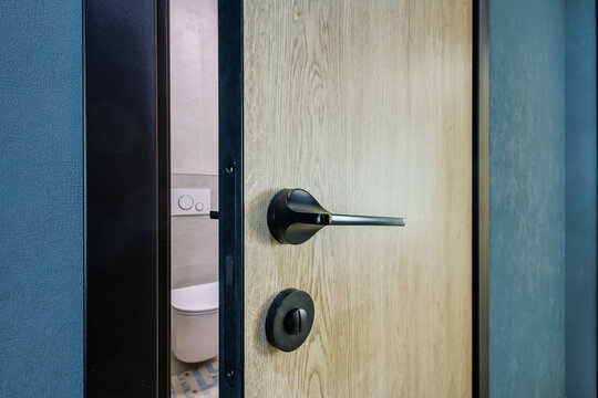 door handle on white wooden door in interior. Knob close-up elements. Door handle, fittings for interior design