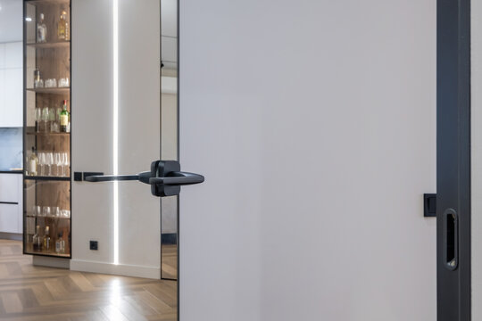 door handle on white wooden door in interior. Knob close-up elements. Door handle, fittings for interior design