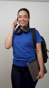 Young latina female student talking on the phone