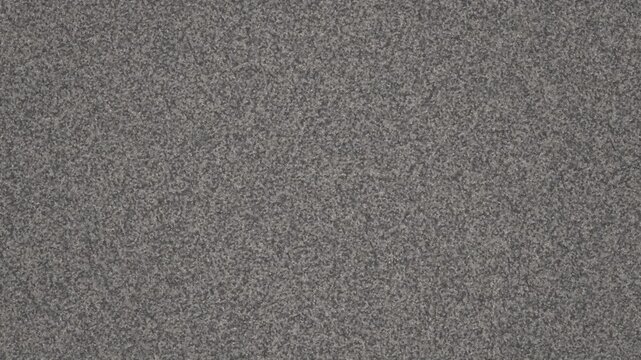 Close up textured background of grey carpet with subtle variations in tone and fiber detail