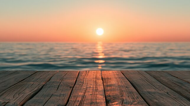 Warm sunset over calm sea seen from old wooden dock planks, golden evening light reflection on water for travel vacation and relaxation concept design