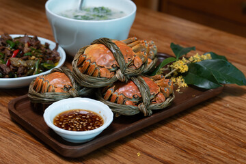 steamed hairy crabs tied with straw on wooden tray © 浩 康