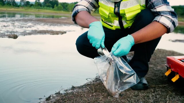 Environmental researcher collecting water and sediment samples for heavy metal contamination analysis.