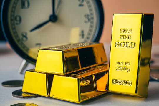Gold bars with an alarm clock, time and gold investment, long-term wealth, patience, time management, and financial security concept