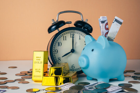 Gold bars with an alarm clock, time and gold investment, long-term wealth, patience, time management, and financial security concept
