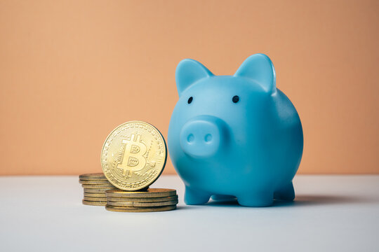 Blue piggy bank with a stack of golden cryptocurrency coins, digital saving, representing digital currency, blockchain, investment, saving, and the future of finance concept