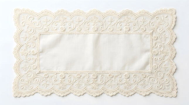 Elegant cream colored rectangular lace doily with intricate floral embroidery on a white background