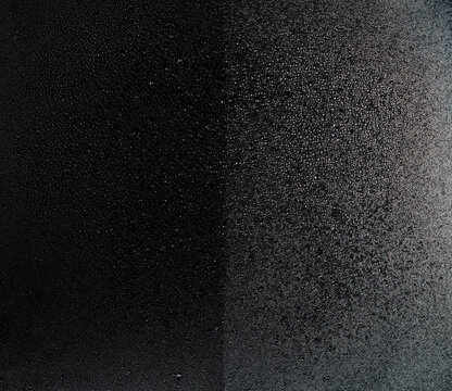 Rain water fall on car front glass before after coating to reduce surface tension. Water droplet and bead on glass combine into big drop and fall down. Abstract background, high speed photograph