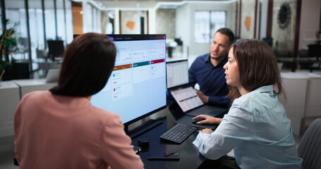 Naklejka na ściany i meble IT Manager Reviews Access Requests With Diverse Team