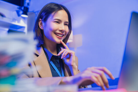 Young Asian businesswoman working on laptop in office, professional corporate employee and digital business concept.