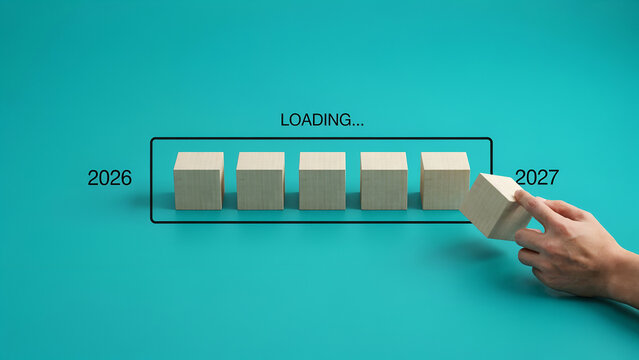 Wooden blocks arranged in loading bar progress concept representing transition between years twenty twenty six and twenty twenty seven
