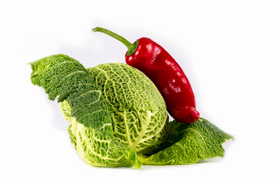 Head of Savoy cabbage and red sweet pepper on a white background