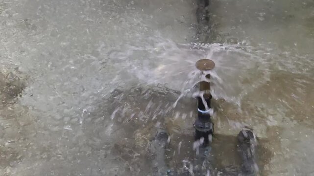 water fountain nozzle spraying fresh water spray in concrete pond outdoor close up view
