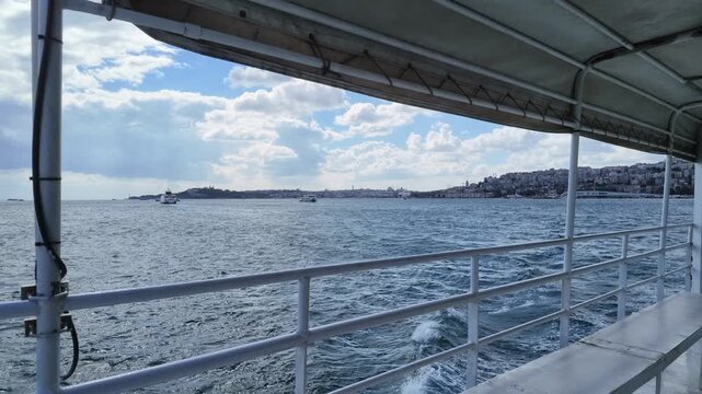 a view of the Bosphorus Strait in Istanbul taken from the deck or railing of a passenger ferry