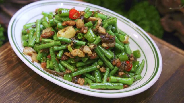 Stir-fried crispy cowpeas with preserved olives and minced meat is a classic Chinese home-style dish.