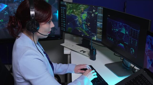 logistics operator using GPS radar and real-time fleet management dashboard on computer.