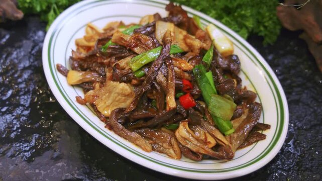 Chinese home-style hot dish: stir-fried mushrooms and sliced meat with garlic sauce