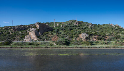 View of the Cachon River with coastal shrubland and rocky hills near Cabo de la Plata in Zahara de los Atunes, Cadiz, Andalusia, Spain © ihervas