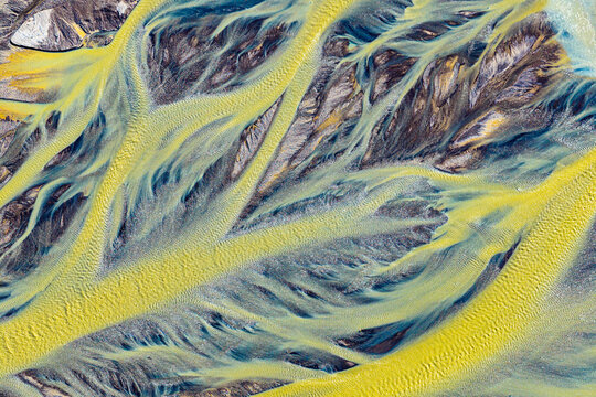 Aerial abstract view of braided yellow river patterns