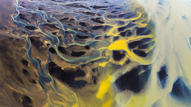 Yellow sediment and water patterns in a glacial river