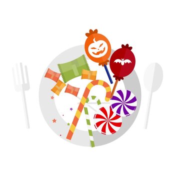 Halloween candy on plate with fork and spoon featuring festive treats like lollipops and gummy sweets against clean white background for holiday celebrations