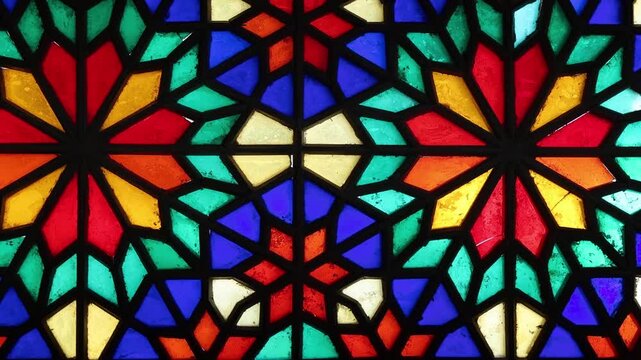 Vibrant stained glass windows with intricate Persian Orosi latticework and geometric patterns inside the historic Dowlatabad Garden pavilion in Yazd, Iran, showcasing traditional Iranian architecture.