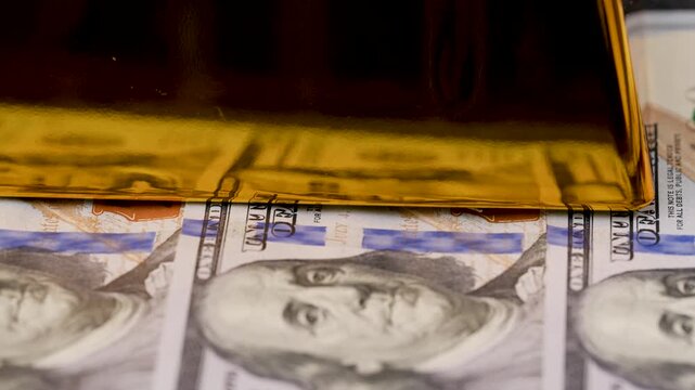 video of a gold bar with dollar bills