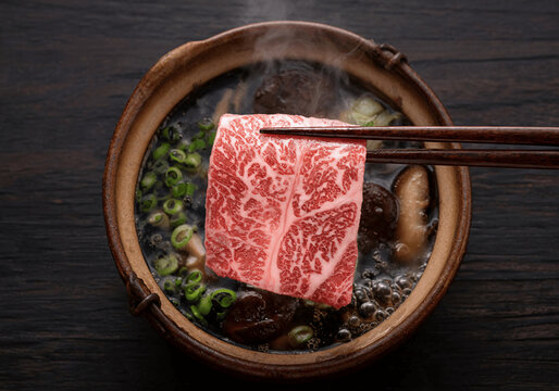 Japanese Sukiyaki with Marbled Beef, Shiitake Mushrooms, and Green Onions in Broth