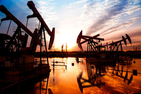 The oil pump, industrial equipment. Oil field site, oil pumps are running.