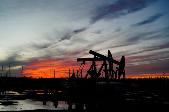 The oil pump, industrial equipment. Oil field site, oil pumps are running.