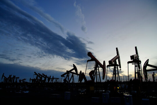 The oil pump, industrial equipment. Oil field site, oil pumps are running.