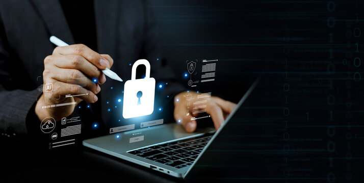 Business person using a laptop with glowing cybersecurity lock and data protection interface. Concept of information security, digital privacy, data encryption, and network safety system.