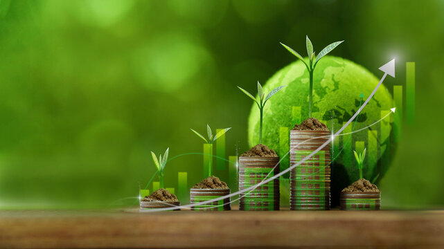 Green seedlings growing on rising coin stacks with a digital globe and financial chart background. Represents sustainable investment, financial growth, green business and global economic progress.