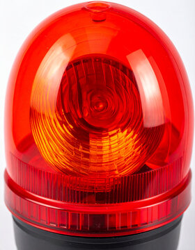 Bright red warning beacon on white background, minimalist industrial aesthetic. Close-up.