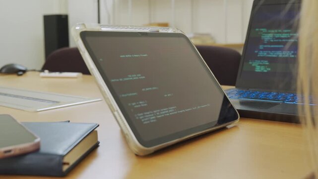 Programmer or IT checking code cybersecurity or website on laptop, tablet at home office for concept verifying code algorithm. Employees woman write code on computer software development. Remote work.