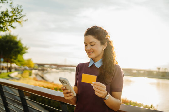 Woman shopping online using smartphone and credit card