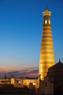 The Islam Khoja Minaret, a historic structure in Khiva, Uzbekistan, at dusk