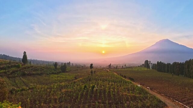Scenic Sunrise over Mount Sumbing and Agricultural Fields in Central Java Indonesia