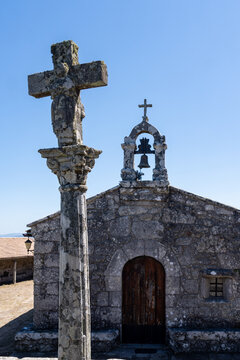 The Chapel of Santa Trega (or Santa Tecla) next to its traditional stone cross,