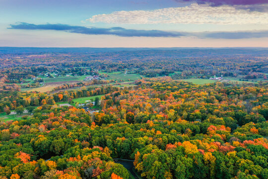 Hampton Township, Sussex County, NJ, surrounded by brilliant fall foliage at dusk aerial drone