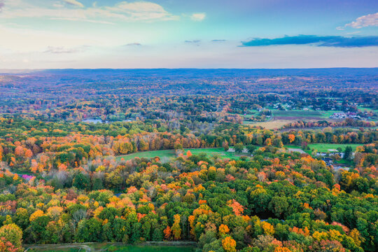 Hampton Township, Sussex County, NJ, surrounded by brilliant fall foliage at dusk aerial drone