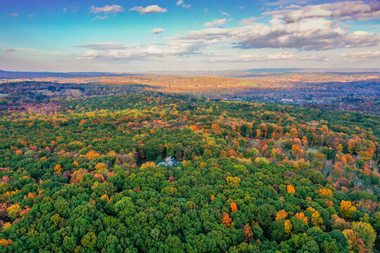 Hampton Township, Sussex County, NJ, surrounded by brilliant fall foliage at dusk aerial drone
