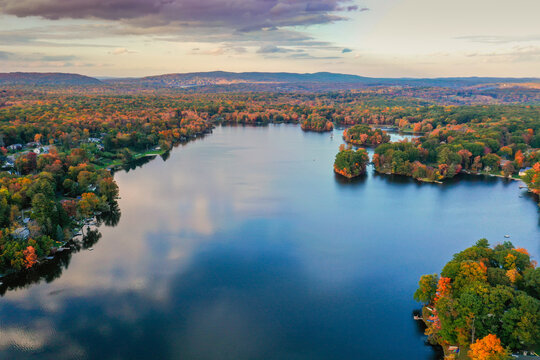 Kemah Lake in Hampton Township, Sussex County, NJ, surrounded by brilliant fall foliage at dusk aerial drone