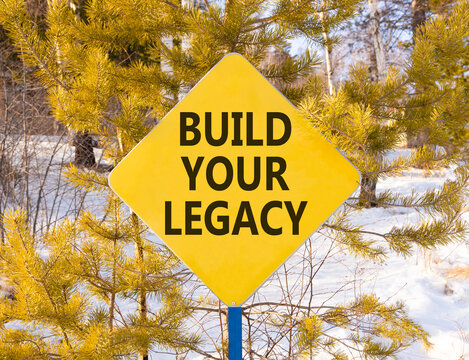 Build your legacy words symbol. Concept words Build your legacy on beautiful yellow road sign. Beautiful winter forest background. Business build your legacy concept. Copy space.